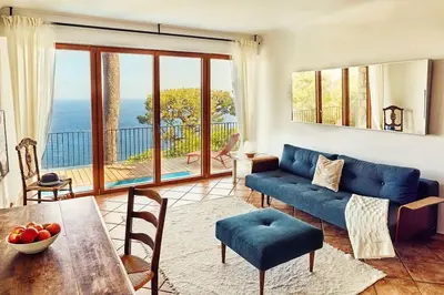 a living room with a blue couch and a table at Best View ever! in Èze