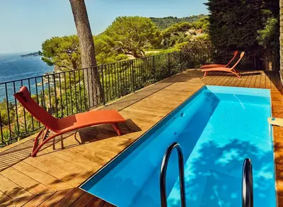 a swimming pool with two chairs and a table at Best View ever! in Èze