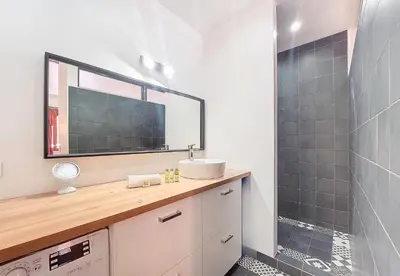 a bathroom with a sink and a shower with a mirror at Nestor&Jeeves - ESCAPADE - Central - Near Beach in Nice