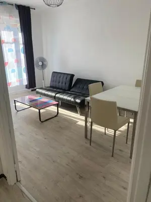 a living room with a couch and a table at Appartement Flores in Nice