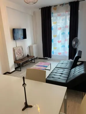 a living room with a couch and a table at Appartement Flores in Nice