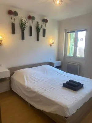 a bedroom with a bed with two towels on it at Historic Bright and Beautiful Apartment in Old Nice with Castle Hill View in Nice