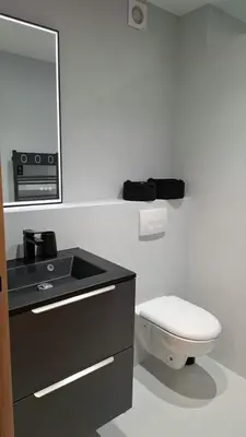 a bathroom with a toilet and a sink and a mirror at Historic Bright and Beautiful Apartment in Old Nice with Castle Hill View in Nice