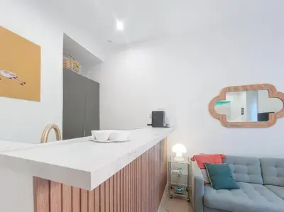 a kitchen with a counter and a blue couch at Nestor&Jeeves - BEL AIR - City Center - Modern in Nice