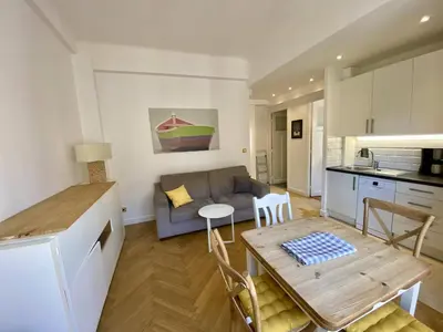 a kitchen and living room with a table and a couch at Nice Hypercentre- Joli 2Pièces in Nice