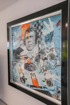 a framed picture of a man with his hand up at Appartement exception les pieds dans l'eau in Èze