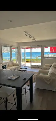 a living room with a couch and a coffee table at Appartement exception les pieds dans l'eau in Èze