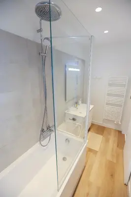 a glass shower in a bathroom with a sink at Appartement exception les pieds dans l'eau in Èze