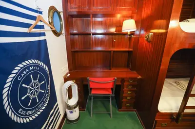 a small room with a desk and a red chair at Appartement exception les pieds dans l'eau in Èze
