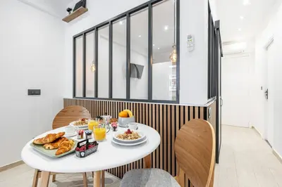 a table with breakfast food on it in a room at MY CASA - SMOLETT - Superb Studio Suite Downtown w AC in Nice