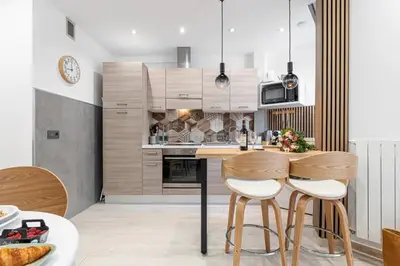 a kitchen with a table and two stools at MY CASA - SMOLETT - Superb Studio Suite Downtown w AC in Nice