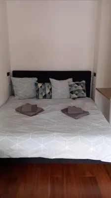 a large bed with white sheets and pillows at Very Nice Apartment in Nice