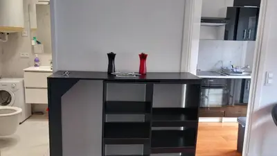 a kitchen with a black counter in a room at Very Nice Apartment in Nice