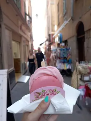 a person holding a pink ice cream in a wrapper at Very Nice Apartment in Nice