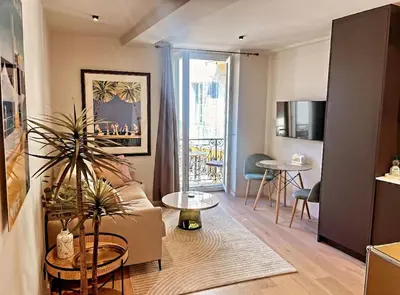 a living room with a couch and a table at Masséna street, 2 rooms balcony in Nice