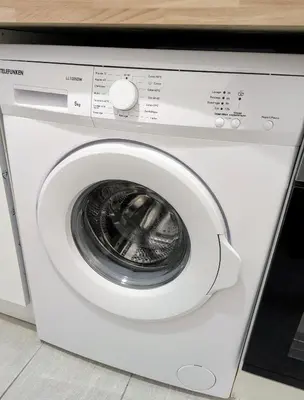 a white washing machine with its door open at 3 Pièces 70m2 Coeur de Nice in Nice