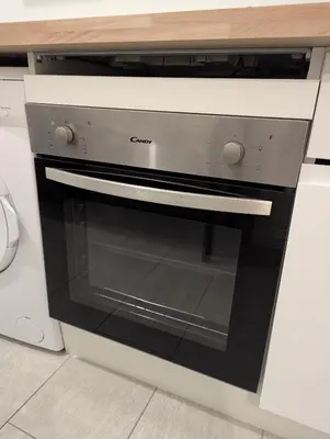 a kitchen with a black and white oven at 3 Pièces 70m2 Coeur de Nice in Nice