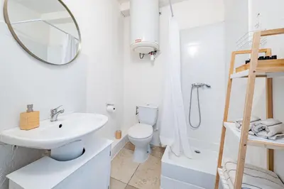 a white bathroom with a sink and a toilet at Charmant Appartement 2P au Cœur du Vieux Nice in Nice