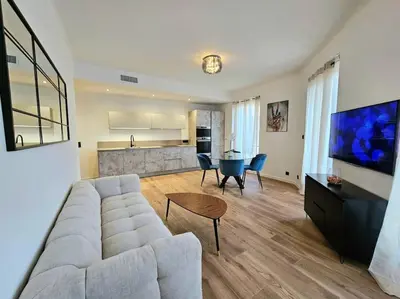 a living room with a couch and a table at Très bel appartement Nice centre in Nice