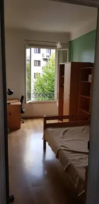 a bedroom with a bed and a large window at Appartement lumineux in Nice