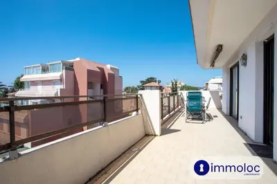 a balcony of a building with a chair on it at Air-conditioned apartment with park and swimming pool à Cagnes in Cagnes-sur-Mer