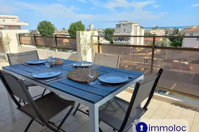 a blue table with chairs on a balcony at Air-conditioned apartment with park and swimming pool à Cagnes in Cagnes-sur-Mer