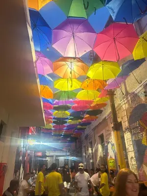 a room with colorful umbrellas hanging from a ceiling at Le Grand Ruisseau in Nice