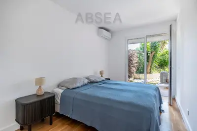 a bedroom with a bed and a large window at Nice Absea Fabron 2 in Nice