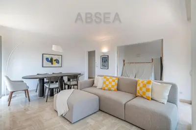 a living room with a couch and a table at Nice Absea Fabron 2 in Nice