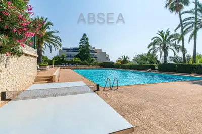 a swimming pool in a resort with palm trees at Nice Absea Fabron 2 in Nice