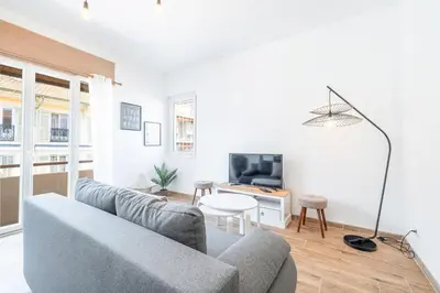 a living room with a couch and a tv at Large & Quiet 1 Bdr Downtown in Nice
