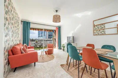 a living room with a table and chairs at Large 2 Bdr Close to the Beach Balcony & Garage in Nice