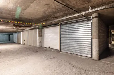 an empty parking garage with two garage doors at Large 2 Bdr Close to the Beach Balcony & Garage in Nice
