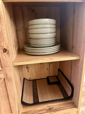 a stack of plates and bowls on a wooden shelf at Jungle avec Jaccuzi au coeur de Nice in Nice