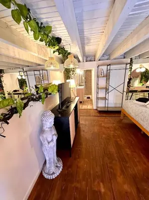 a room with plants on the wall and a bed at Jungle avec Jaccuzi au coeur de Nice in Nice