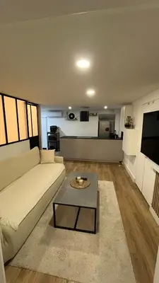 a living room with a white couch and a table at Appartement au port de Nice, proche des plages in Nice