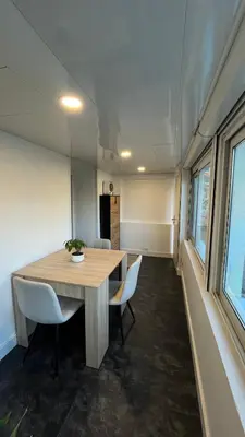 a dining room with a wooden table and chairs at Appartement au port de Nice, proche des plages in Nice