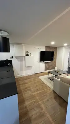 a white living room with a couch and a table at Appartement au port de Nice, proche des plages in Nice