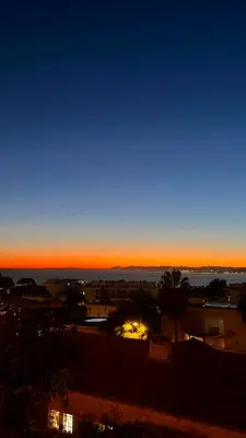 a sunset view of a city with the sky at Appartement au port de Nice, proche des plages in Nice