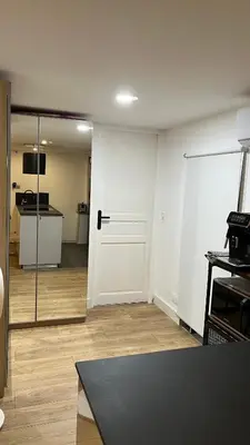 an empty living room with a door and a kitchen at Appartement au port de Nice, proche des plages in Nice