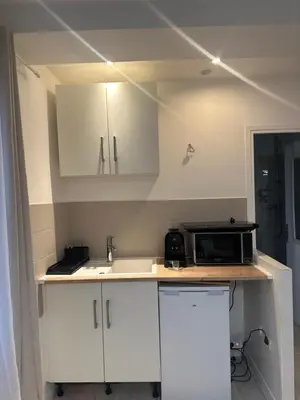 a kitchen with a sink and a microwave on a counter at Carras in Nice