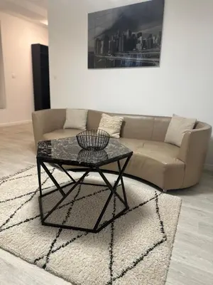 a living room with a couch and a table at Carras in Nice
