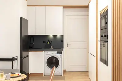 a kitchen with a washing machine in a white kitchen at #51 1BDR Massena,central 5 min to the beach AC in Nice