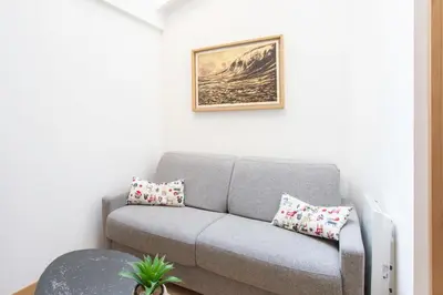 a living room with a gray couch with pillows at #51 1BDR Massena,central 5 min to the beach AC in Nice