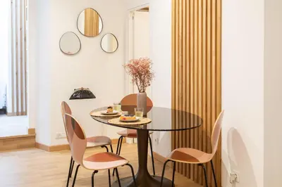 a dining room with a round table and chairs at #51 1BDR Massena,central 5 min to the beach AC in Nice