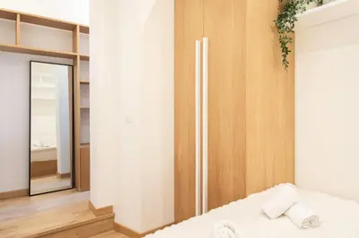 a bedroom with a bed and a mirror at #51 1BDR Massena,central 5 min to the beach AC in Nice