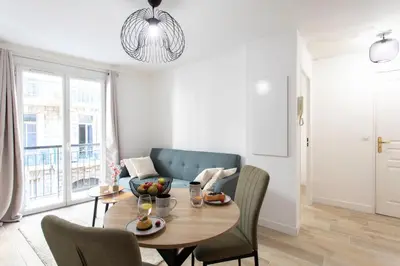 a living room with a table and a couch at #58 Logement Clim & Balcon 5mins marche de la Mer in Nice