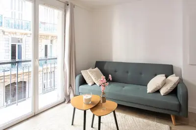 a living room with a green couch and a table at #58 Logement Clim & Balcon 5mins marche de la Mer in Nice