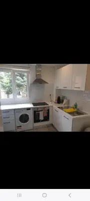 a kitchen with white cabinets and a stove top oven at Grand Appartement, 2 ou 3 ou 4 pieces, tramway sur place, proche gare sncf St Augustin 5 min, aéroport à 7 min, plage ou Allianz riviera 10 min, palais nikaia 2 min , supermarché sur place, parking possible si disponible ou payant à 1000 metre in Nice