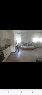 a large room with a bed in the middle of it at Grand Appartement, 2 ou 3 ou 4 pieces, tramway sur place, proche gare sncf St Augustin 5 min, aéroport à 7 min, plage ou Allianz riviera 10 min, palais nikaia 2 min , supermarché sur place, parking possible si disponible ou payant à 1000 metre in Nice
